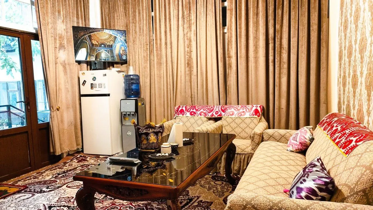 Shared lounge with sofa, fridge and water cooler
